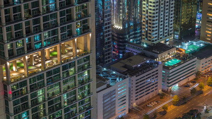 Fototapeta na wymiar Rooftop swimming pool on the top of skyscraper near Sheikh Zayed Road in Dubai aerial night timelapse, UAE.