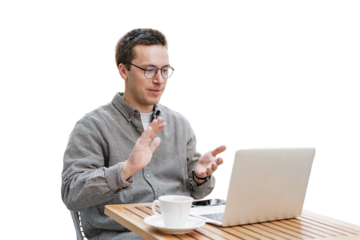 Video call the man is working, uses a laptop and a phone, answers the client. Freelancer communication workplace and computer online surf site.