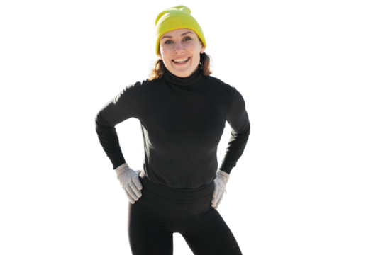 A sporty woman in a winter yellow hat and gloves, smiling and looking at the camera.