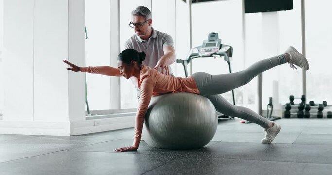 Fitness, exercise ball and woman with personal trainer in gym, help with workout and health, balance and muscle. Strong, wellness and people with training gear, coach and support during challenge