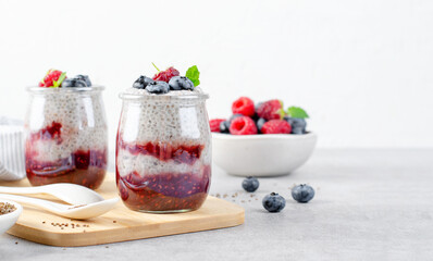 Healthy Chia Pudding in a Glass with Raspberry Jam and Fresh Berries