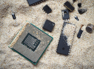Semiconductor components on the sand. Cpu, microchip, integrated circuits, transistors and diodes. 