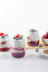 Healthy Chia Pudding in a Glass with Raspberry Jam and Fresh Berries