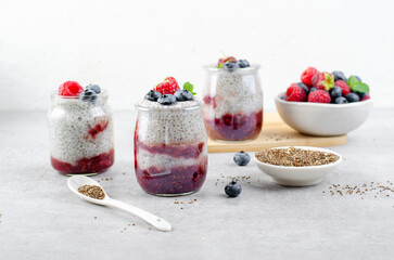 Healthy Chia Pudding in a Glass with Raspberry Jam and Fresh Berries