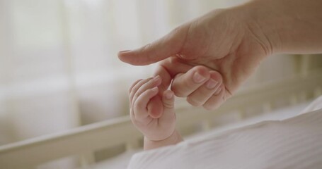 Closeup on baby cute tiny hand gripping mother finger. Cropped view on mom tenderly touching and hold newborn hand. Maternity concept - Powered by Adobe
