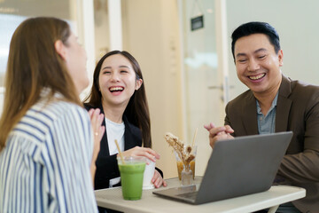 Group of diverse ethnicity businesspeople, Asian and Western business person, have business discussing in the coffee shop. Out of office working in modern lifestyles concept.