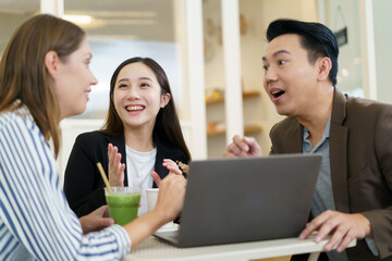Group of diverse ethnicity businesspeople, Asian and Western business person, have business discussing in the coffee shop. Out of office working in modern lifestyles concept.