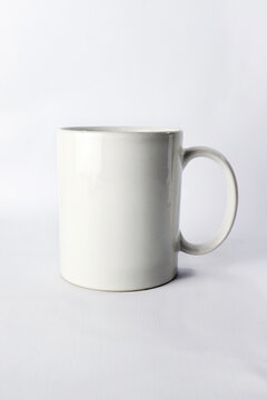 an empty ceramic white cup  isolated on white background.