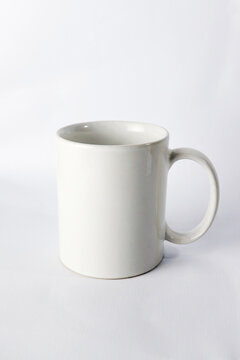 an empty ceramic white cup  isolated on white background.