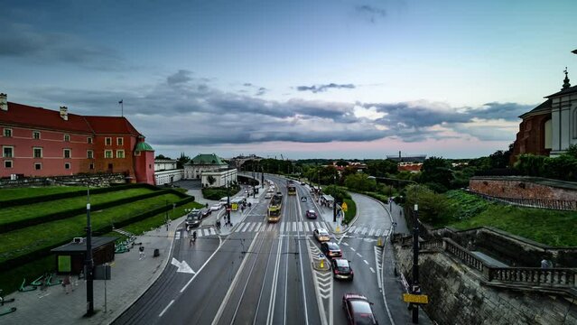 4K Time Lapse, floating clouds at sunset over traf ic on a streen in historical center of Warsaw, Poland