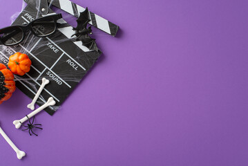 Unveil the essence of Halloween excitement with an intriguing snapshot showcasing film clapper and creepy decorations on isolated purple backdrop, offering an inviting space for your promotional text