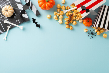 Spooky Cinema Setup: Top view of themed decorations featuring bone-adorned popcorn boxes and eerie...