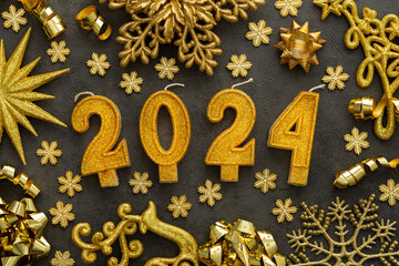 Merry Christmas and Happy New Year 2024, 2024 cake candles and various holiday decorative ornaments in gold color on gray background