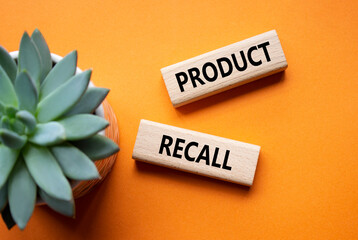 Product recall symbol. Concept words Product recall on wooden blocks. Beautiful orange background...