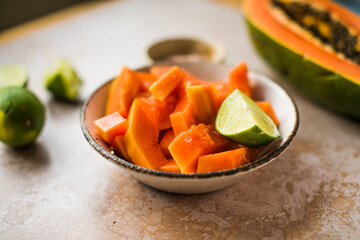 Papaya pieces with lime and salt on  plate cooking food