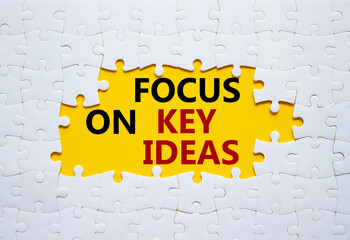 Focus on Key Ideas symbol. Concept word Focus on Key Ideas on white puzzle. Beautiful yellow...