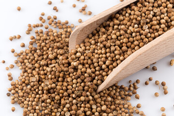 Coriander seeds in wooden scoop