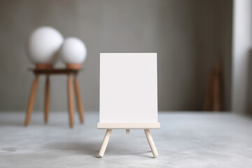 Small blank white card table sign, mockup of miniature toy blank white canvas on table.