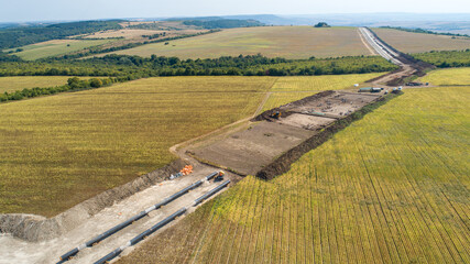 Aerial view of gas and oil pipeline construction. Pipes welded together. Big pipeline is under...