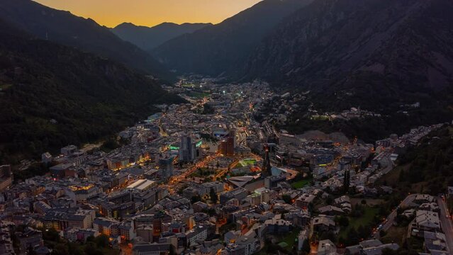 Day to night aerial hyperlapse of Andorra La Vella in the middle of mountains