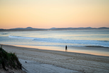 walking on the beach at dusk on an australian sandy beach