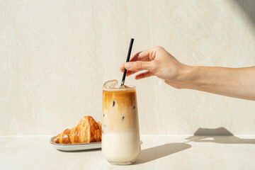 Still life of Cold brew coffee drink with ice and croissant. Delicious morning breakfast