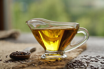 Flax seed oil in a glass jug on a table