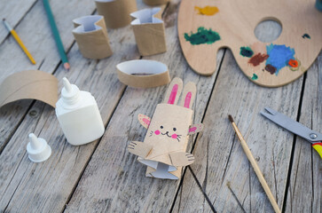 Kids craft bunny out of recycling toilet paper roll, zero waste concept.