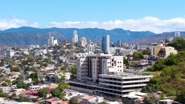 Aerial dollyshot with zoom in to buildings of Tegucigalpa, capital city of Honduras during a sunny day