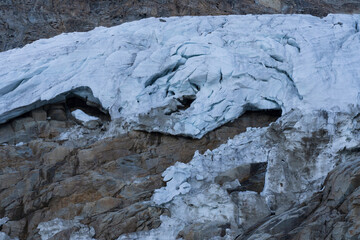 Glacier in the alpine mountains, crevasses and ice details. Gran Paradiso National Park mountaineering. global warming melting the ice.