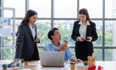 Selective focus of male employee holding coffee cup.