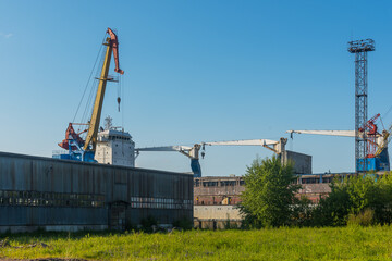 shipbuilding cranes in the repair port there is a ship under repair nearby