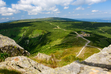 Giant Mountains, mountain panorama from the hiking trail to the top of Sniezka. View of the vast mountain slopes and trails on a sunny summer day.