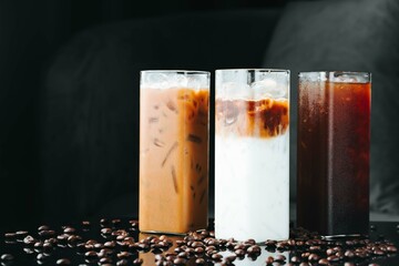 Ice coffee in a tall glass, cold iced coffee on a dark background, summer drink