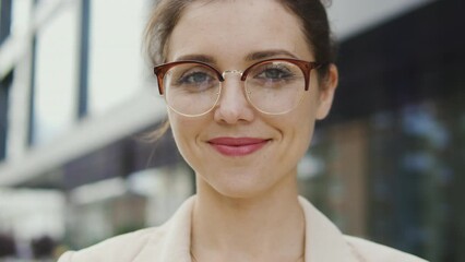 Attractive woman eyeglasses standing outdoor, natural beauty and purity close-up
