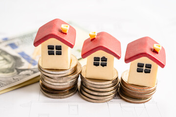 House model with stack of coin money, home loan, saving plan, installment payment finance and banking concept.