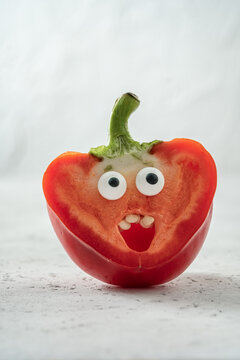 Naklejki Surprised funny red pepper with a candy eyes