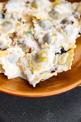 ravioli cream sauce pasta meal food snack on the table copy space food background rustic top view 