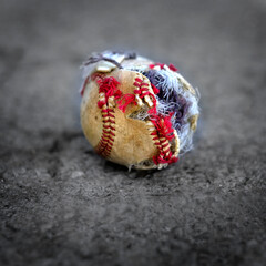 Closeup of Old Worn Ragged Baseball Torn Cover for Sport