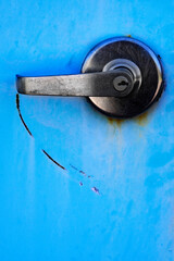 Metal Handle on Blue Metal Door with Lock for Security Scratch Mark