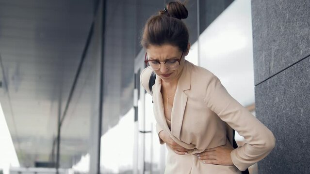 Young woman feeling crumps in her stomach, unhealthy eating, constipation