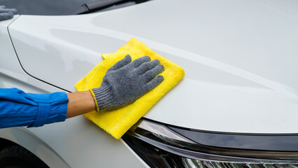Man cleaning the car with a clean cloth, washing the car, wiping the car, polishing the car, wiping...