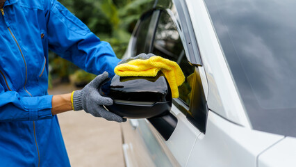 Man cleaning the car with a clean cloth, washing the car, wiping the car, polishing the car, wiping dust