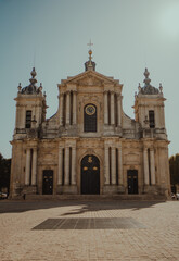 An old church with sun shining through on a cobblestone street