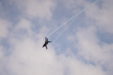 Fototapeta na wymiar Fighter jet flying in the sky doing maneuver 