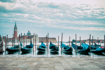 Picture with gondolas moored on Grand Canal near Saint Mark square, in Venice Italy with Church of...