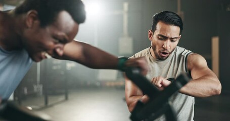 Man, cycling and personal trainer in motivation for fitness workout, exercise or training at the gym. Male person coaching or timing athlete on bicycle, machine or equipment in cardio at health club