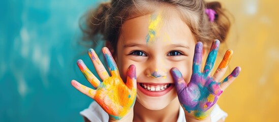 Young girl creating children s makeup with a brush and painted hands Beauty joy childhood and art theme Empty space for design or text