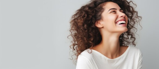 Closeup portrait of happy woman laughing at joke gesturing retreating after hearing compliment or tackle on gray studio background with copy space - obrazy, fototapety, plakaty