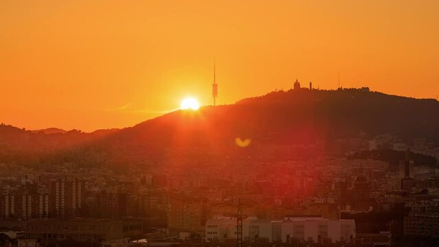 Dawn over Tibidabo mountain and Barcelona city skyline